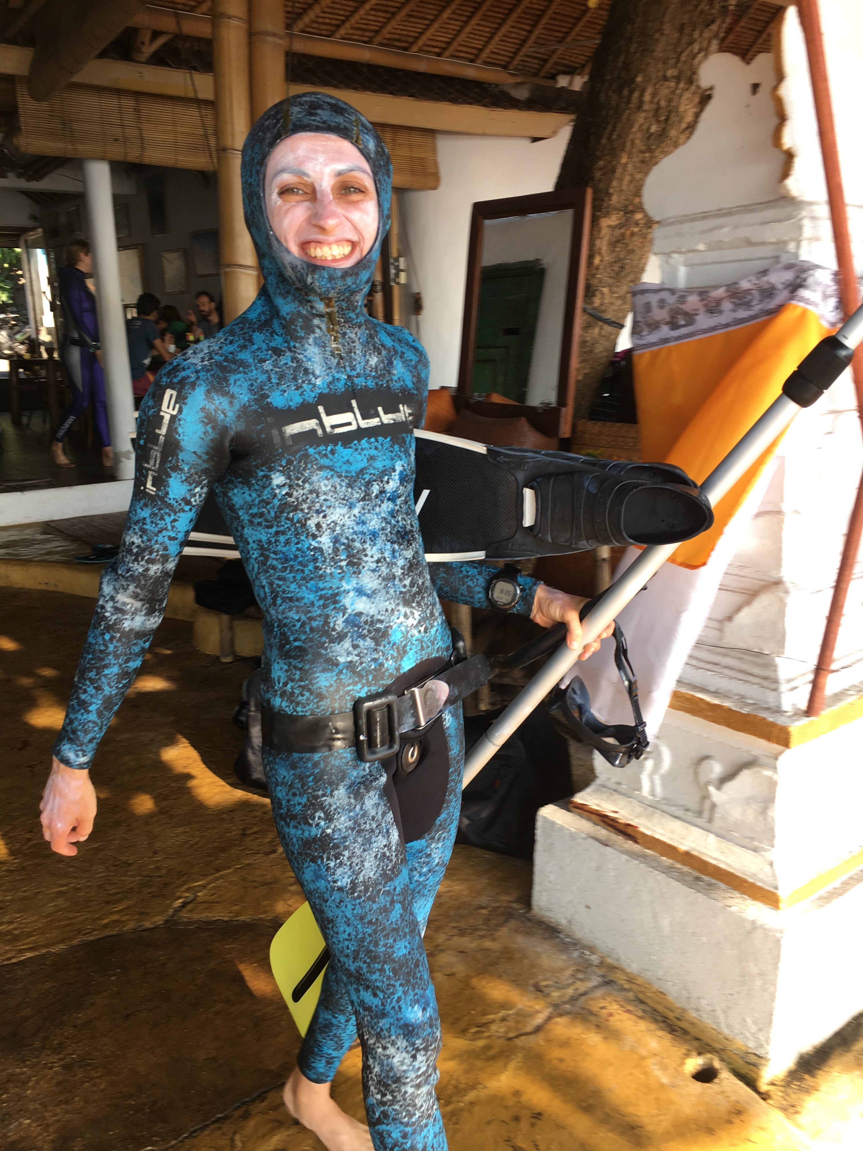 Freediver ready for the water with sunblock and fins in Apneista Bali Amed