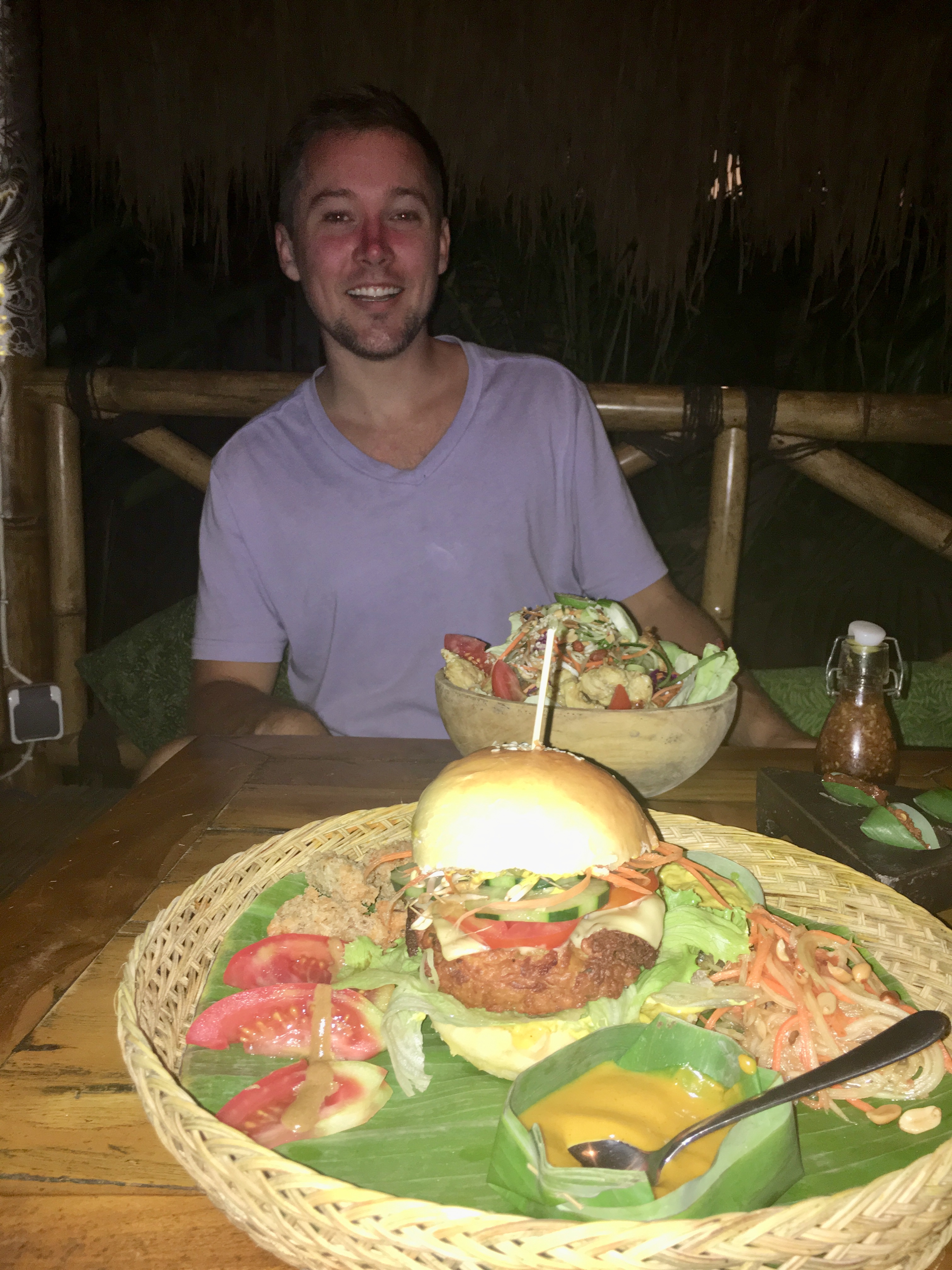Enjoying tempeh burger at Galanga in Amed Bali with a friend